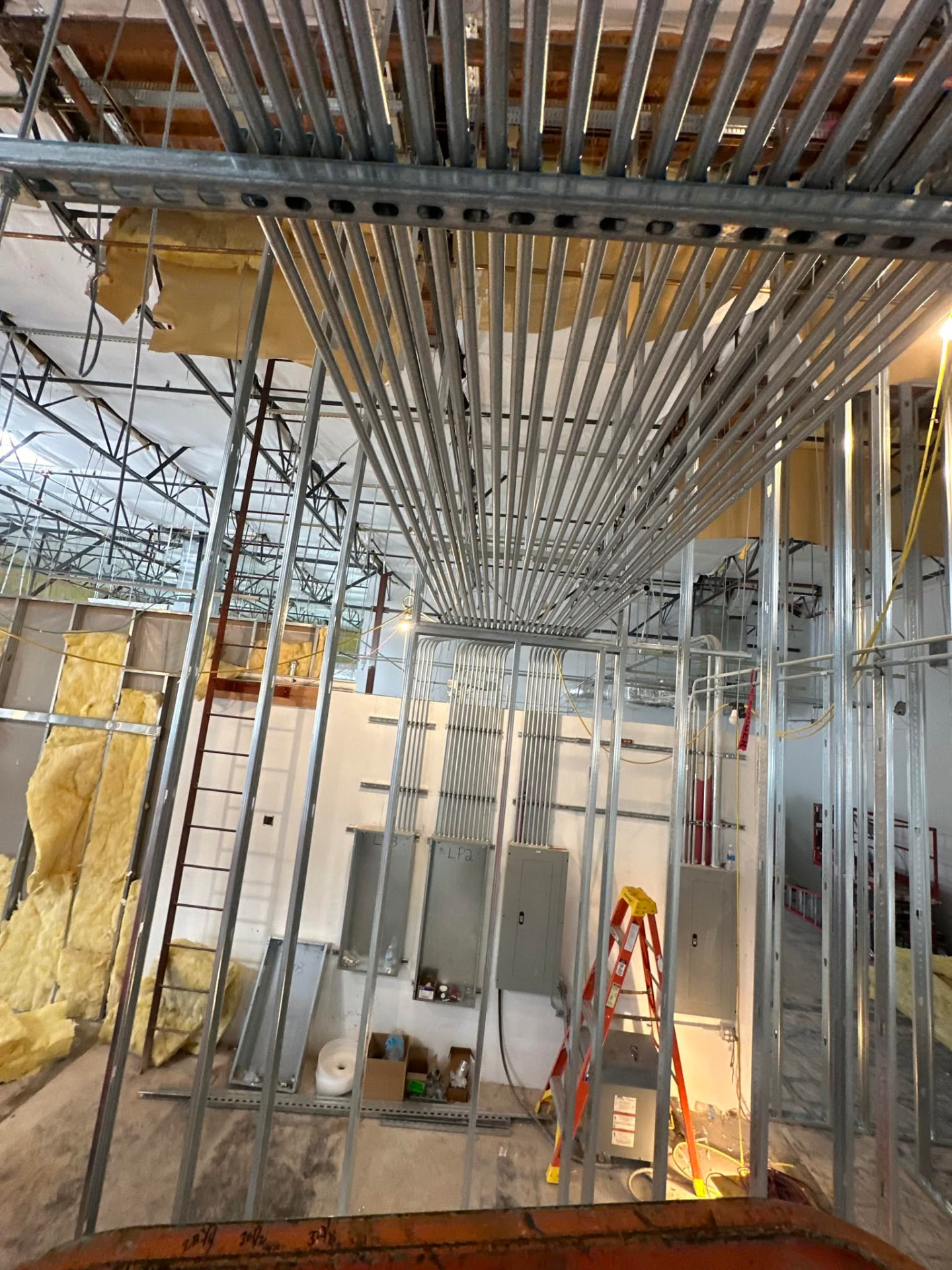 Electrical panels and conduit rough-in inside an Arizona commercial building under construction