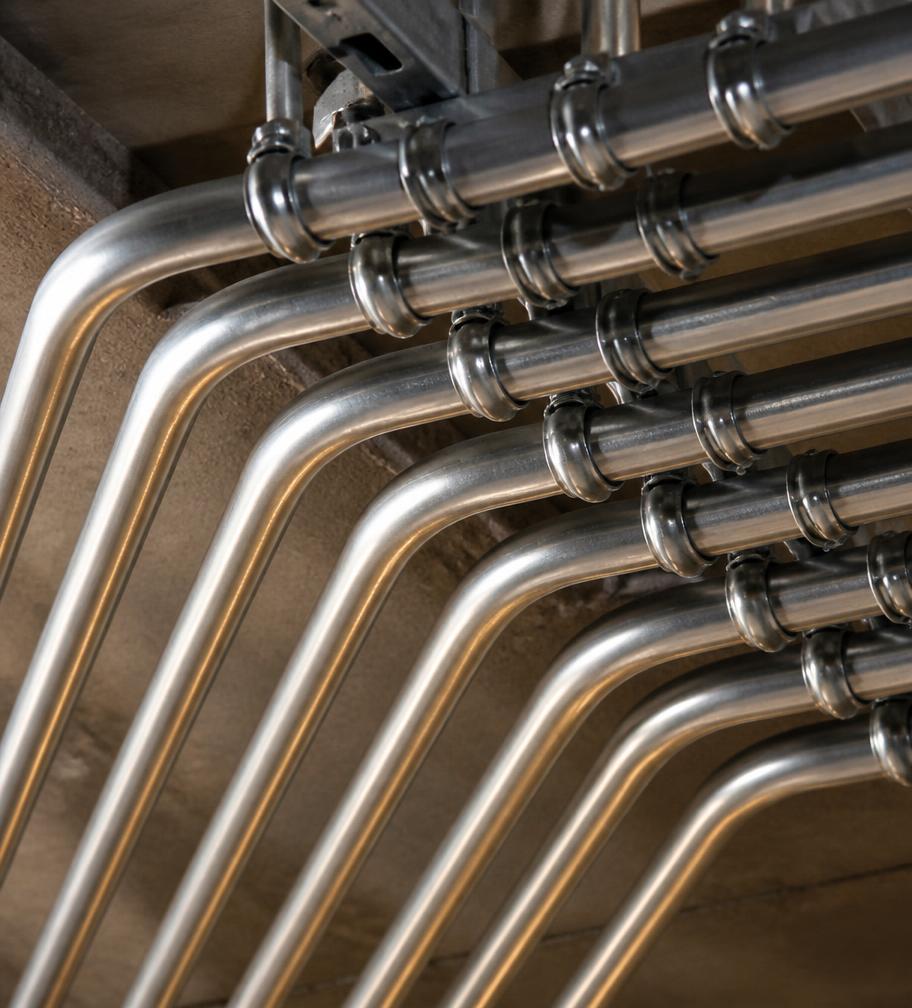 Neatly bent parallel conduit runs along a ceiling